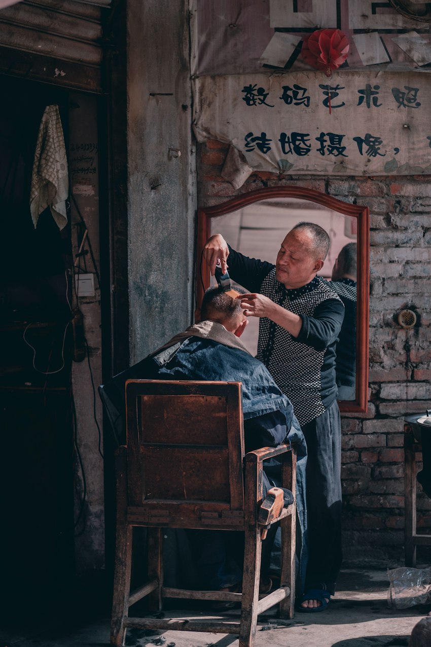 Traditional barber working on a client's haircut