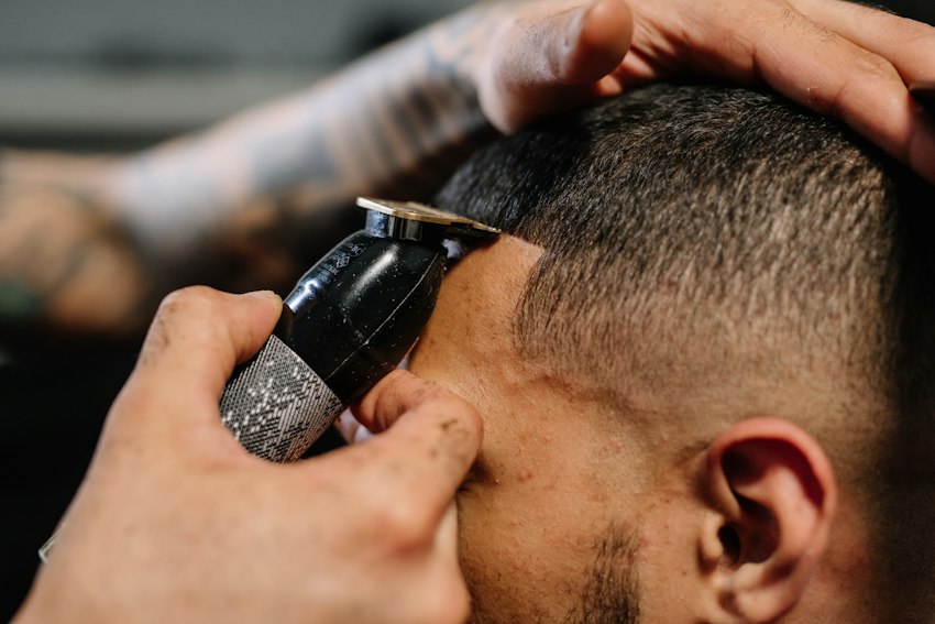 Barber refining a close skin fade